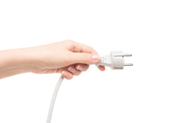 Female hand holds electric plug on a white background.