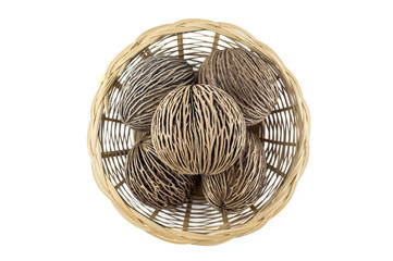 dried cerbera oddloam's seed, pong pong seeds in basket on white