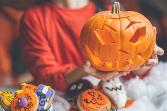 Boy holding a jack-o-lantern halloween pumpkin