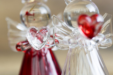 Crystal glass angel with red heart in the hands. room for text 
