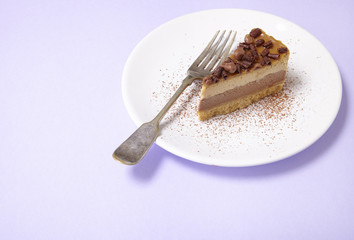 A slice of toffee cheesecake pudding on a pastel purple background