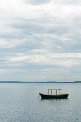 Small boat anchored near shore on calm sea