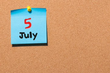 July 5th. Day 5 of month, color sticker calendar on notice board. Summer time. Empty space for text