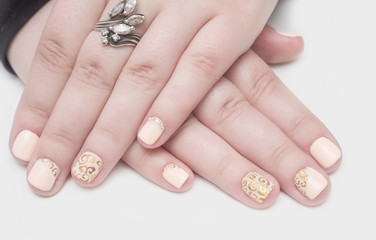 Multi-colored jelly sweets in the hands with a bright nail polish