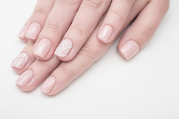 Multi-colored jelly sweets in the hands with a bright nail polish