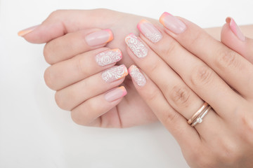 Multi-colored jelly sweets in the hands with a bright nail polish