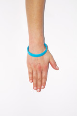 Blue blank rubber wristband on wrist arm. Silicone fashion round social bracelet wear  hand. Unity band.