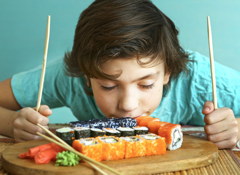 preteen handsome boy with sushi roll set