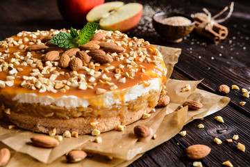 Apple cake with whipped cream, caramel and almond topping