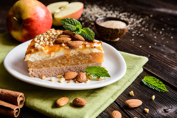 Apple cake with whipped cream, caramel and almond topping