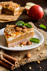 Apple cake with whipped cream, caramel and almond topping