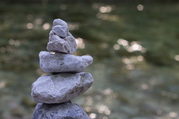 Stone pyramide with river on backbaround peace symbol