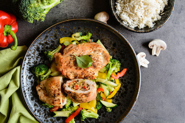 Roasted chicken breasts stuffed with vegetable and sheep cheese, served with steamed vegetable and rice