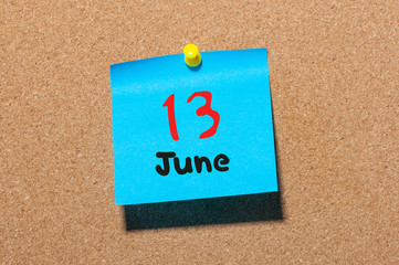 June 13th. Day 13 of month, color sticker calendar on notice board. Summer time. Close up