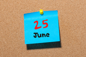 June 25th. Day 25 of month, color sticker calendar on notice board. Summer time. Close up