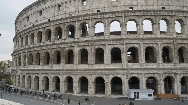 Tourists viewing ancient Colosseum amphitheatre, sightseeing tour to Rome, Italy