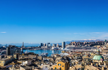 Obraz premium GENOA, ITALY, February 1 2015: Panoramic view of old city and port of Genoa in a winter day under a beautiful blue sky / landscape/city/ view/ port/ city/ blue/ sky