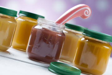 healthy ready-made baby food on a wooden table