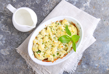 Cauliflower baked with cheese in a white bowl