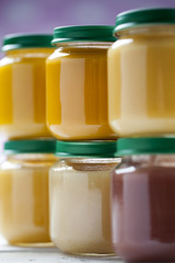 healthy ready-made baby food on a wooden table