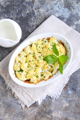 Cauliflower baked with cheese in a white bowl