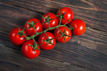 Fototapeta na wymiar Fresh cherry tomatoes on wood background.