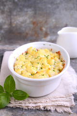 Cauliflower baked with cheese in a white bowl