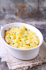 Cauliflower baked with cheese in a white bowl