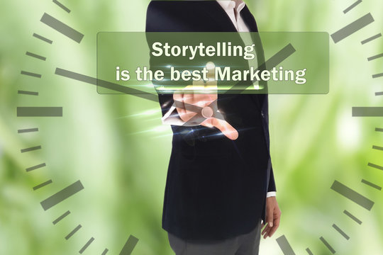 business, technology, internet and networking concept - businessman pressing Storytelling is the best Marketing button on virtual screens, blurred of green nature outdoor bokeh background