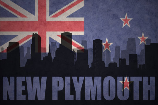 abstract silhouette of the city with text New Plymouth at the vintage new zealand flag