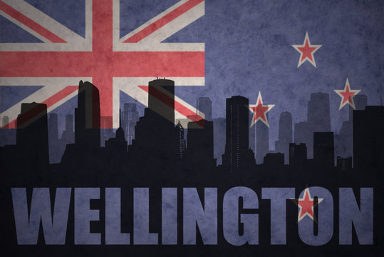 abstract silhouette of the city with text Wellington at the vintage new zealand flag