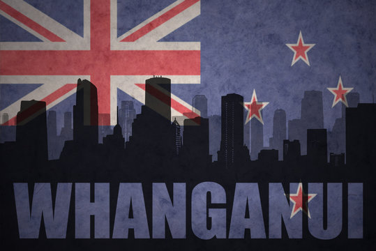 abstract silhouette of the city with text Whanganui at the vintage new zealand flag
