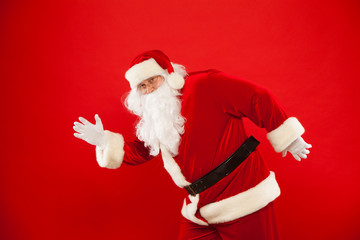 Running Santa Claus red background Merry Christmas.