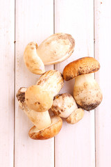 White mushrooms on a white wooden background