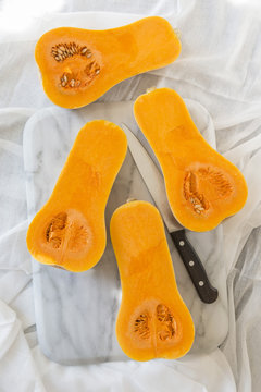 Sliced Butternut Squash On A Marble Chopping Board.