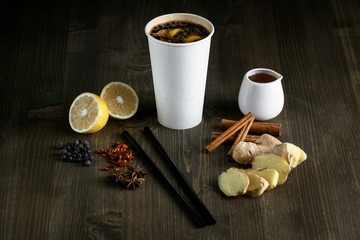 Drink in a white cup with fruit on a wooden background