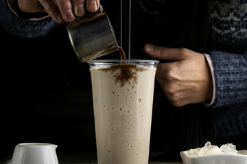 Milk drink in clear glass on the wooden table