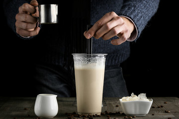 Milk drink in clear glass on the wooden table