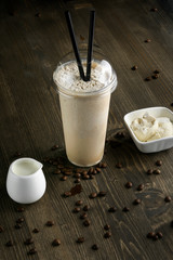 Milk drink in clear glass on the wooden table