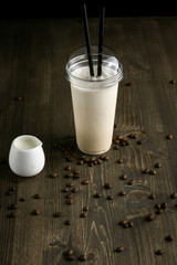 Milk drink in clear glass on the wooden table