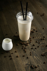 Milk drink in clear glass on the wooden table