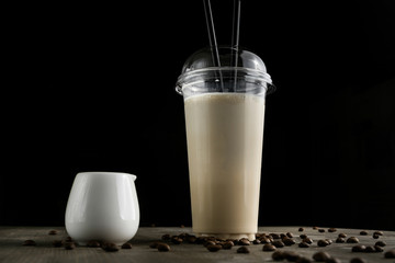 Milk drink in clear glass on the wooden table