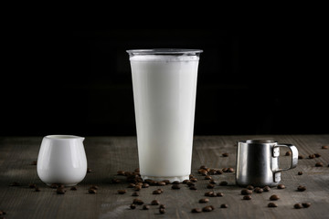 Milk drink in clear glass on the wooden table
