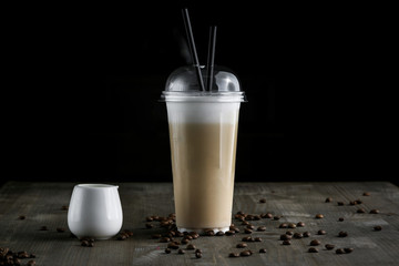 Milk drink in clear glass on the wooden table
