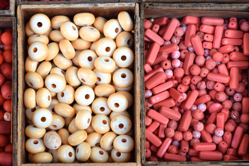 background with decorative beads,white and red colors in wooden boxes