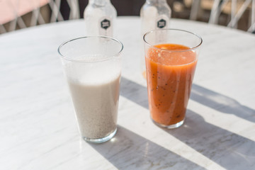 Two smoothies: vanilla and melon orange