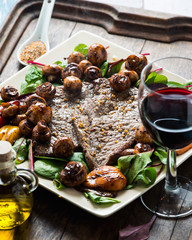 Frying beef steak with mushrooms and baby leaf salad