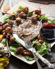 Frying beef steak with mushrooms and baby leaf salad