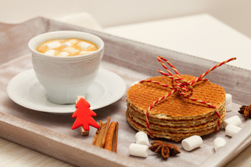 Fototapeta na wymiar Cup of coffee with sweet cookies and xmas decorations