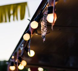 Vintage antique hanging light bulbs at a street food market. Holidays and business good idea...